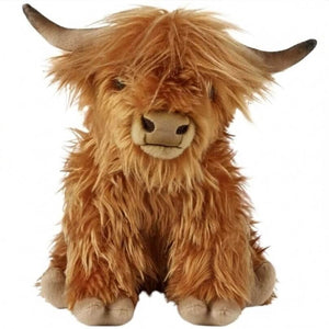 Plush toy Highland cow on a white background