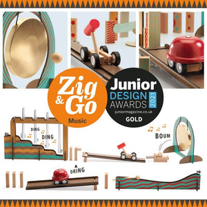 A collage of wooden toy music instruments and sound-making pieces on a white background, with a large orange and black 'Zig & Go Music' badge and a 'Junior Design Awards 2024 Gold' seal. Visible products include a gong, wooden train cars, a red bell-shaped sound box, blocks, and a striped sound barrier.